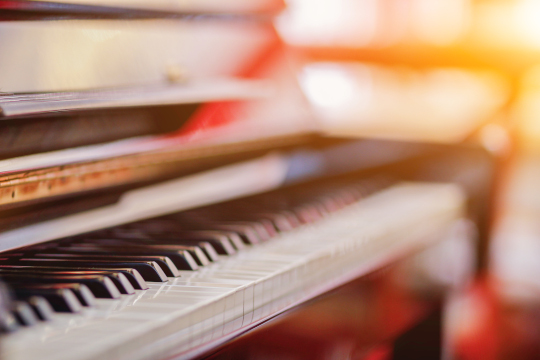 Beautiful piano background are set by the window in the morning waiting for the pianist to come to practice in the morning to reduce the mistake of having to perform the piano performance at a concert