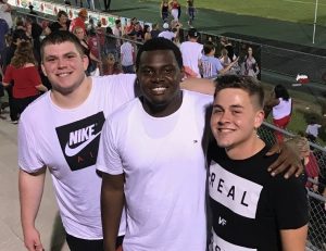 Albert Fuller with friends at football game. (Left to right: Grayson Moore, Albert and Travis Coleman)